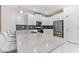 Bright kitchen with a quartz countertop island and seating; stainless appliances and gray backsplash at 8833 Cruden Bay Ct, Davenport, FL 33896