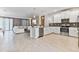 Open concept kitchen featuring stainless steel appliances, white cabinetry, and a breakfast bar at 8833 Cruden Bay Ct, Davenport, FL 33896