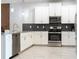 Modern kitchen with stainless steel appliances, light cabinets, and backsplash at 8833 Cruden Bay Ct, Davenport, FL 33896
