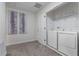 Bright laundry room with modern washer and dryer and neutral wall art at 8833 Cruden Bay Ct, Davenport, FL 33896