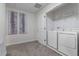 Bright laundry room with a white washer and dryer and closet shelving at 8833 Cruden Bay Ct, Davenport, FL 33896
