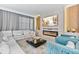 Bright living room features a cozy fireplace, plush seating, and contemporary decor at 8833 Cruden Bay Ct, Davenport, FL 33896