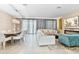 Open-concept living and dining area is filled with natural light and designer furnishings at 8833 Cruden Bay Ct, Davenport, FL 33896