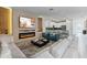 Open-concept living space with an electric fireplace, sofa, and kitchen view at 8833 Cruden Bay Ct, Davenport, FL 33896
