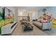 A spacious living room with Paw Patrol wall decor, comfortable couches, and ample seating at 8833 Cruden Bay Ct, Davenport, FL 33896