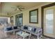 Covered patio with comfortable seating, ceiling fans, and an outdoor space for relaxation at 8833 Cruden Bay Ct, Davenport, FL 33896