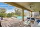 Screened-in pool and spa, with outdoor seating and a spacious brick patio, perfect for entertaining at 8833 Cruden Bay Ct, Davenport, FL 33896