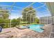 View of the screened in pool and spa, with outdoor lounge chairs at 8833 Cruden Bay Ct, Davenport, FL 33896