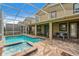 Screened in pool and spa, with outdoor dining and seating area at 8833 Cruden Bay Ct, Davenport, FL 33896