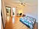 Bright bedroom features a ceiling fan, wood floors, and a doorway to an adjacent bathroom at 912 Lake Destiny Rd # F, Altamonte Springs, FL 32714
