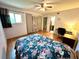 Bright bedroom featuring a ceiling fan, wood floors, and a doorway to an adjacent bathroom at 912 Lake Destiny Rd # F, Altamonte Springs, FL 32714