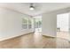 Airy bedroom with natural light, wood-look flooring, and sliding glass door to backyard at 950 Vanessa Ct # F, Port Orange, FL 32127