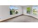 Bright bedroom with large windows and neutral carpet offers peaceful views of lush greenery at 950 Vanessa Ct # F, Port Orange, FL 32127