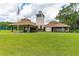 Beautiful community clubhouse features a clock tower and lush green lawn at 950 Vanessa Ct # F, Port Orange, FL 32127