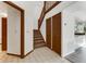 Bright foyer featuring tile floors, stairs to the second floor, and convenient coat closet at 950 Vanessa Ct # F, Port Orange, FL 32127