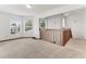Open living room features multiple windows for natural light and wood railing to the downstairs at 950 Vanessa Ct # F, Port Orange, FL 32127