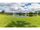 Scenic pond view with lush green lawn and surrounding community buildings at 950 Vanessa Ct # F, Port Orange, FL 32127