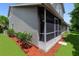 View of the screened porch, the exterior and the beautiful landscaping at 950 Vanessa Ct # F, Port Orange, FL 32127