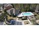 Aerial view of a neighborhood pool with lounge chairs, playground, and community building at 9575 Silver Buttonwood St, Orlando, FL 32832