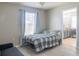 Cozy bedroom with a ceiling fan, a large window, and an ensuite bathroom at 9575 Silver Buttonwood St, Orlando, FL 32832