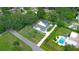 Aerial view of a beautiful home with a pool, screened enclosure, shed, and lush green landscaping at 103 Longhorn Rd, Winter Park, FL 32792