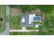 Aerial view showcasing the home, pool, and surrounding landscape in a serene, green neighborhood at 103 Longhorn Rd, Winter Park, FL 32792