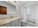 Bright bathroom with marble countertop, white tile, and walk-in shower at 103 Longhorn Rd, Winter Park, FL 32792