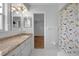 Updated bathroom with granite countertops and dinosaur themed shower curtain at 103 Longhorn Rd, Winter Park, FL 32792