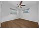 Comfortable bedroom featuring wood floors, a ceiling fan, and two windows at 103 Longhorn Rd, Winter Park, FL 32792