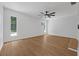 Bedroom with a ceiling fan, neutral paint, wood-look flooring, and natural light from two windows at 103 Longhorn Rd, Winter Park, FL 32792
