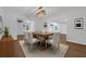 Bright dining room featuring modern light fixtures, wooden dining table with seating for six, and wood-look floors at 103 Longhorn Rd, Winter Park, FL 32792