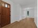 Entryway featuring wood-look flooring, white walls and trim, and a wooden front door with glass paneling at 103 Longhorn Rd, Winter Park, FL 32792