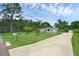 Exterior of a single story home with a lush lawn and a long driveway at 103 Longhorn Rd, Winter Park, FL 32792