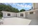 The exterior of a single story home with white paint, white framed windows and a grey roof at 103 Longhorn Rd, Winter Park, FL 32792
