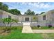 Inviting front porch with a white brick facade, plants, and a walkway, perfect for relaxing outdoors at 103 Longhorn Rd, Winter Park, FL 32792