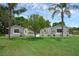 Charming home featuring a well-manicured lawn and palm trees, offering a welcoming curb appeal at 103 Longhorn Rd, Winter Park, FL 32792