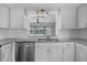 A bright kitchen features white cabinets, granite countertops, and stainless steel appliances at 103 Longhorn Rd, Winter Park, FL 32792