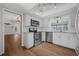 Updated kitchen featuring white cabinets, stainless steel appliances, and seamless access to other living spaces at 103 Longhorn Rd, Winter Park, FL 32792