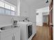 Laundry room with sink and white appliances at 103 Longhorn Rd, Winter Park, FL 32792