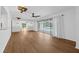 Open living room with wood floors, and a sliding glass door to the pool at 103 Longhorn Rd, Winter Park, FL 32792