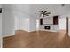 Living room featuring a decorative fireplace, hardwood floors, and built-in bookshelves at 103 Longhorn Rd, Winter Park, FL 32792