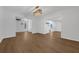 Open concept living room with hardwood floors, white walls, and views into the dining room and kitchen at 103 Longhorn Rd, Winter Park, FL 32792