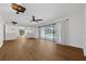 Spacious living room featuring wood floors and a sliding glass door to the pool at 103 Longhorn Rd, Winter Park, FL 32792