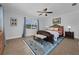 Relax in this main bedroom with a ceiling fan, area rug, a large window with backyard views at 103 Longhorn Rd, Winter Park, FL 32792