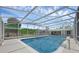 Large pool area with full enclosure for bug-free enjoyment with seating areas for lounging poolside at 103 Longhorn Rd, Winter Park, FL 32792