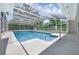 Enclosed pool area with clear overhead screening providing lots of light with easy access from adjacent buildings at 103 Longhorn Rd, Winter Park, FL 32792