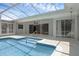 Enclosed pool area featuring tile accents, pool entrance steps and nearby sliding glass door access at 103 Longhorn Rd, Winter Park, FL 32792