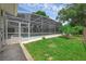 View of the enclosed pool area from the yard featuring a small garden at 103 Longhorn Rd, Winter Park, FL 32792
