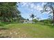 Large front yard with a long, concrete driveway at 103 Longhorn Rd, Winter Park, FL 32792