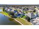 Backyard with a pool, lake view, and a white fence overlooking beautiful landscaping at 10642 Cloudview Dr, Orlando, FL 32825